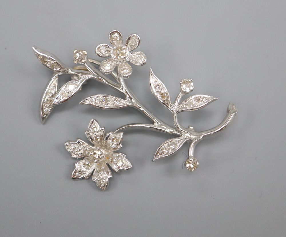An 18ct white gold and diamond flower spray brooch, in Catchpole & Williams box, 4cm, gross 5.8 grams